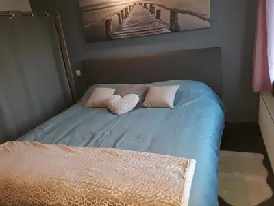 a bed with two stuffed animals sitting on top of it at Villa Marco 176 in Cerexhe-Heuseux