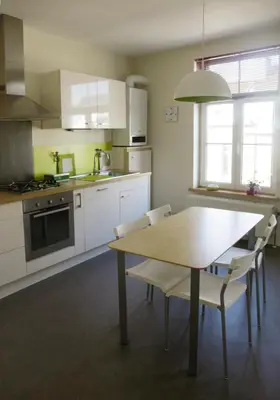 a kitchen with a table and chairs in a kitchen at Aux Herbes Folles in Herve