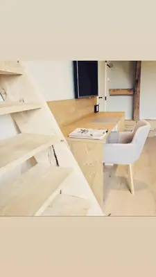 a room with a wooden table and a chair at Winning De Zwaen in Hasselt
