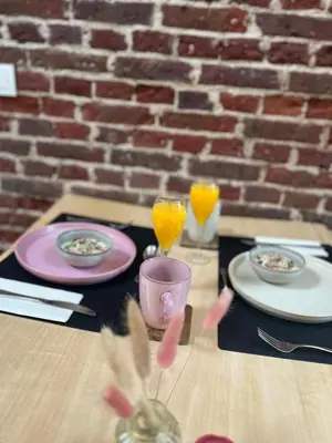 a table with two plates and glasses of orange juice at B&B Bed and Beyond in Oudsbergen