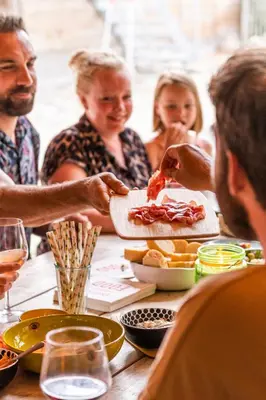 a group of people sitting around a table eating food at B&B Bed and Beyond in Oudsbergen