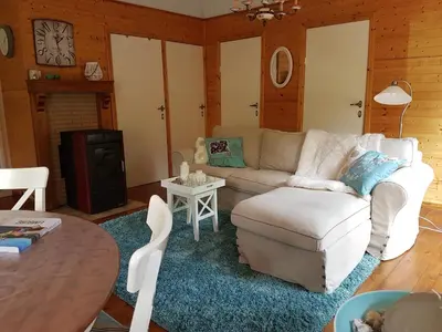 a living room with a couch and a table at Charme chalet in Zutendaal