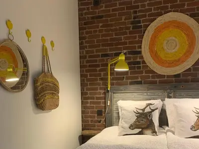 a bedroom with a bed with a brick wall at Vakantiehuis ABEL in Dilsen-Stokkem