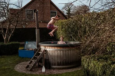 a young man jumping into a hot tub at SintPieter17 Lo-Ghis vakantiewoning in Voeren