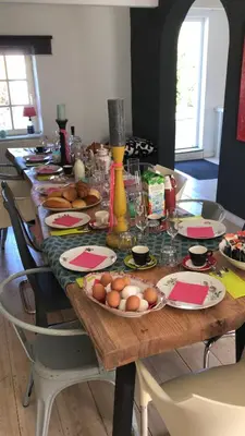 a long table with plates of food and eggs on it at SintPieter17 Lo-Ghis vakantiewoning in Voeren