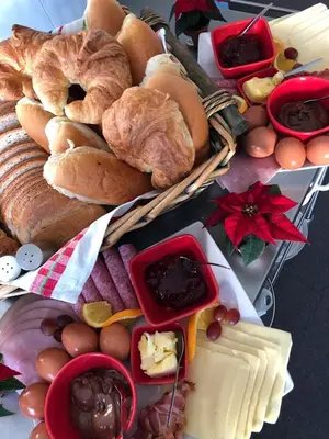 a table topped with baskets of bread and other foods at Vakantiewoning Bij de Jep in Bilzen