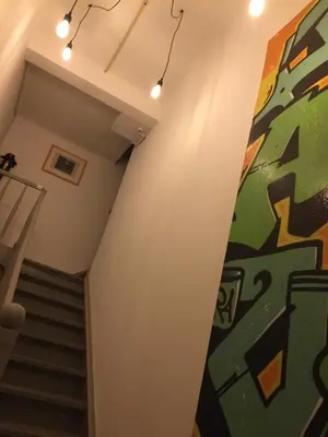 a hallway with stairs and a painting on the wall at L’atelier St Remacle in Liège