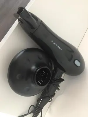 a black hair dryer sitting on a table at L’atelier St Remacle in Liège
