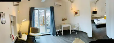 a room with a room with a table and a window at L’atelier St Remacle in Liège