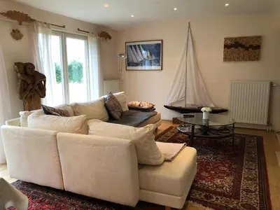 a living room with a white couch and a sail at Landhaus Sylvia in Eupen, Terrasse , Garten & Nähe zum Hohen Venn in Eupen