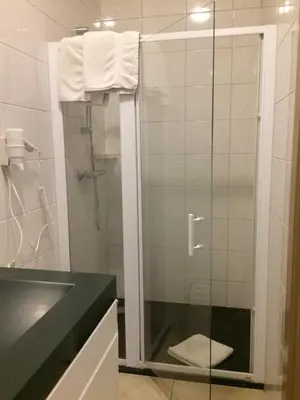 a bathroom with a shower with a glass door at B&B Don Genaro in Dilsen-Stokkem