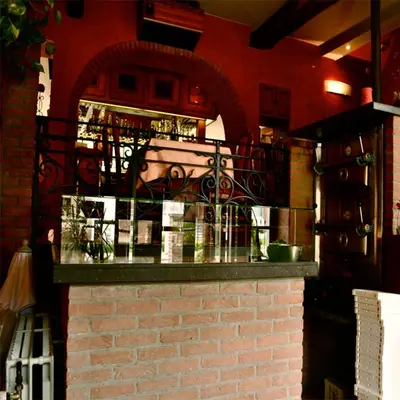 a counter in a restaurant with a brick wall at Hotel IL Castellino in Chaudfontaine