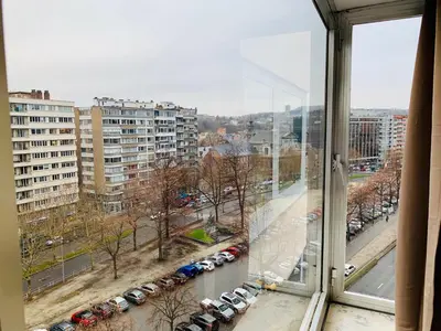 a view from a window of a city with parked cars at Le Cocon d'Avroy in Liège