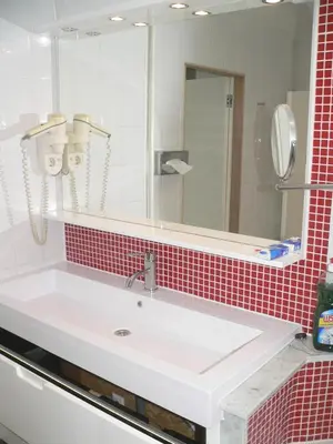 a bathroom with a white sink and a mirror at Liège centre 13 Quai Godefroid Kurth POUR 2 PERS à 25 min gare Guillemins in Liège
