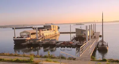 a large boat docked at a dock in the water at Botel Ophoven in Kinrooi