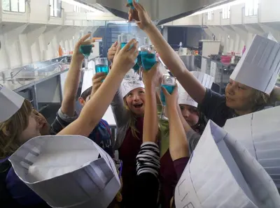 a group of people in a kitchen holding up wine glasses at Botel Ophoven in Kinrooi