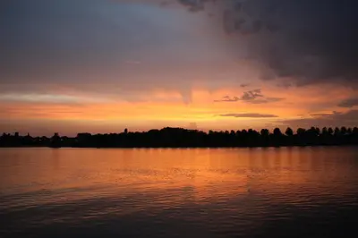 a sunset over a large body of water at Botel Ophoven in Kinrooi
