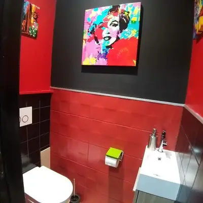 a red bathroom with a sink and a painting on the wall at Vip room 209 in Trooz
