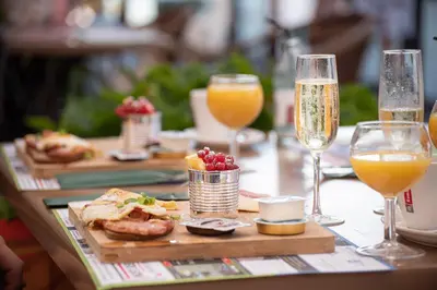 a table topped with glasses of champagne and food at Vakantiewoning Zavelbos in Maaseik