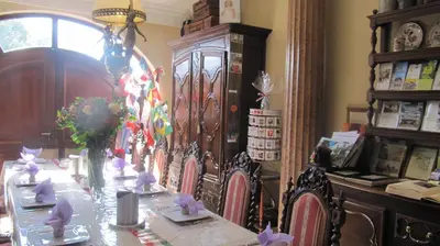 a dining room with a table and chairs with bows at B&B Casa Roman & Vakantiewoning voor 1 pers tot max 32 personen in Zonhoven
