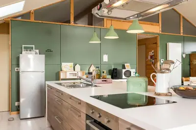 a kitchen with a refrigerator and a counter top at StroEnzo - RUIME LOFT - 5P - 2SLPK - DAKTERRAS - LAADPAAL - 10MIN Maastricht in Riemst