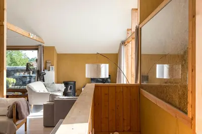 a living room with a wooden table and a couch at StroEnzo - RUIME LOFT - 5P - 2SLPK - DAKTERRAS - LAADPAAL - 10MIN Maastricht in Riemst