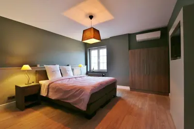 a bedroom with a large bed and a window at AMADIS in Kesselt