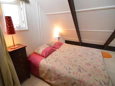 a bedroom with a bed and a lamp and a window at Holiday Home in Gemmenich with Forest Views in Ten Eiken