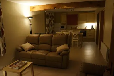 a living room with a couch and a kitchen at Holiday home La ferme brabant in Voeren