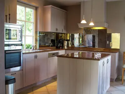 a kitchen with white cabinets and a counter top at Peer Villa with Garden in Peer