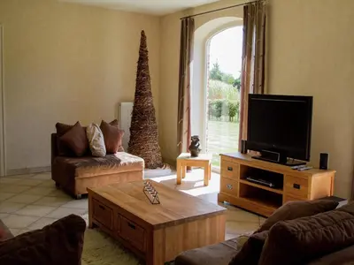 a living room with a tv and a couch and a table at Peer Villa with Garden in Peer