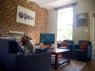 a dog sitting in a chair in a living room at Monastery Retreat in Blossoming Limburg in Sint-Truiden