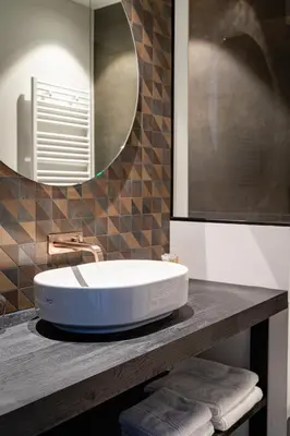 a bathroom with a sink and a mirror at Designhotel Beila in Bilzen