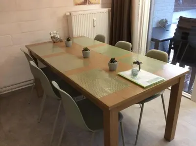 a wooden table with chairs around it with plants on it at Acacia 1 Hengelhoef in Houthalen-Helchteren