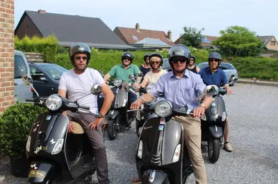 a group of people on scooters in a parking lot at B&B De Vroling in Wellen