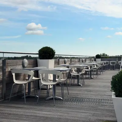 a row of tables and chairs on a deck at Hotel De Pits in Heusden - Zolder