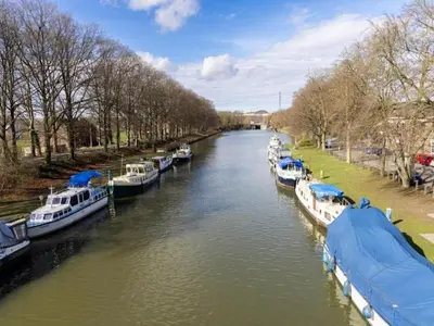 a group of boats docked on a river at Dalhem Villa with Garden in Dalhem