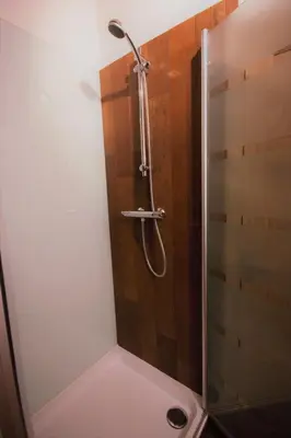a shower with a glass door in a bathroom at B&B Crijbohoeve in Zutendaal
