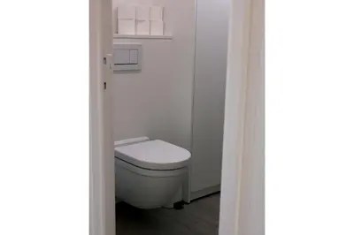 a bathroom with a white toilet in a room at My Secret Garden in Diepenbeek