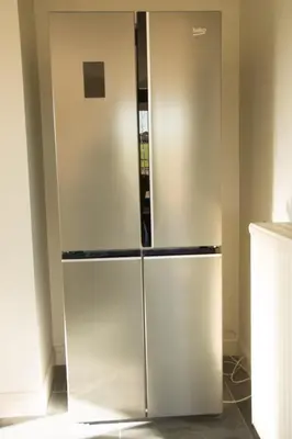 a large stainless steel refrigerator in a kitchen at 'Op de Borgt' met Finse Grill Kota in Wellen