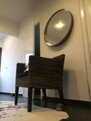 a chair in a room with a mirror on the wall at Villa van Brienen in Dilsen-Stokkem