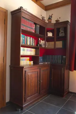 a large wooden book shelf with books on it at Vakantiewoning Het Oude Laer in Bilzen
