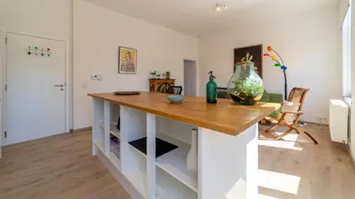 a kitchen with a table with a vase on it at Lyves Two in Liège