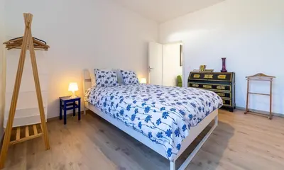 a bedroom with a bed with a blue and white comforter at Lyves Two in Liège