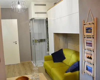 a living room with a yellow couch in a room at 33 Paveestraße in Eupen