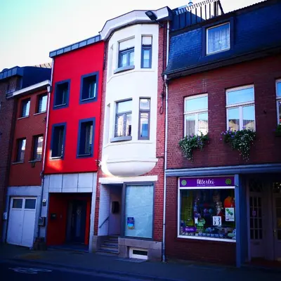 a group of buildings on a city street at 33 Paveestraße in Eupen