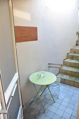 a small green table in a room with stairs at 33 Paveestraße in Eupen
