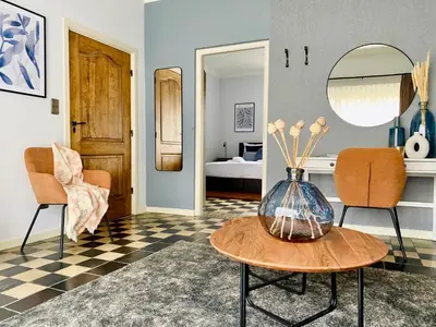 a living room with a vase on a table at Landgoed De Hoogmolen in Oudsbergen