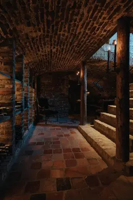 a hallway with stairs and a chair in a building at Amitié in Kinrooi