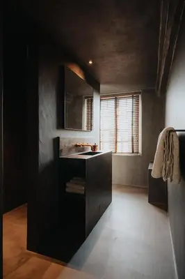 a black bathroom with a sink and a window at Amitié in Kinrooi
